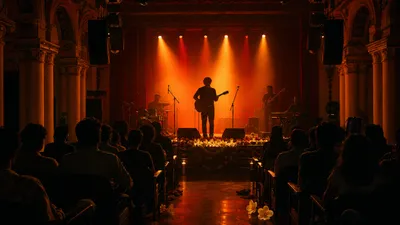 Intimate independent Tamil rock concert with guitar and amber stage lighting