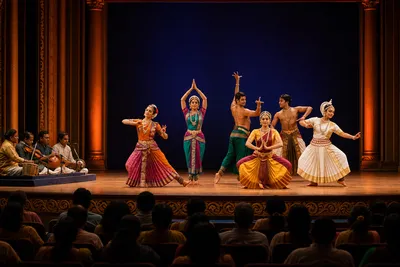 Indian classical dancers performing under warm lights in a Chennai auditorium